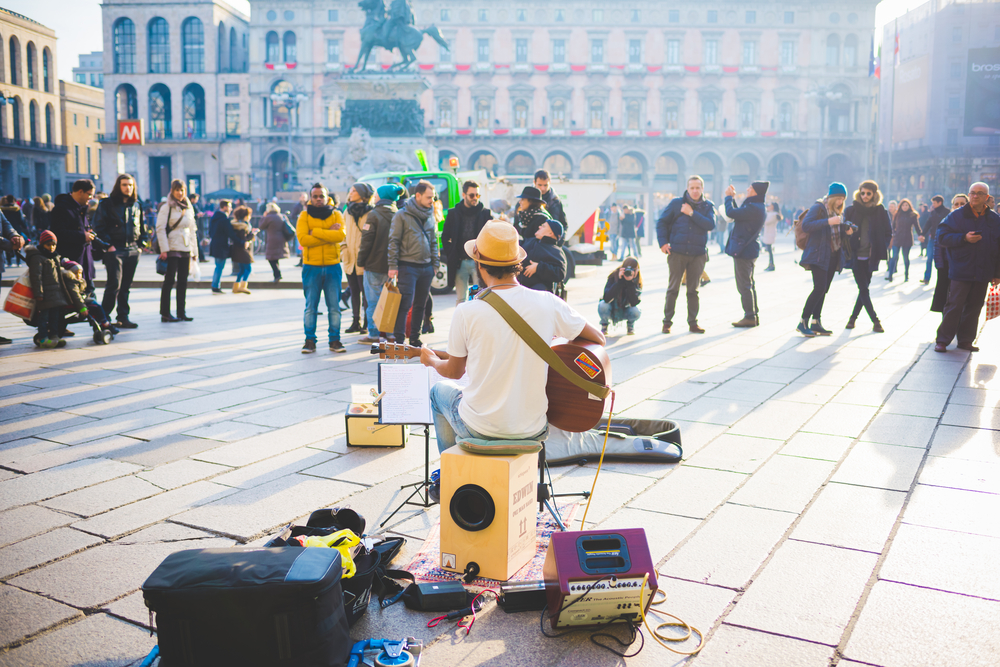 man performing on street to crowd