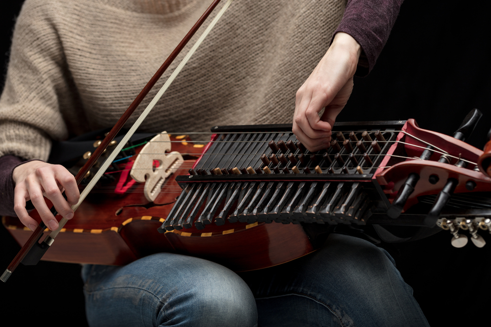 woman tuning nyckelharpa